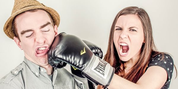 Lady punching a man with a hat
