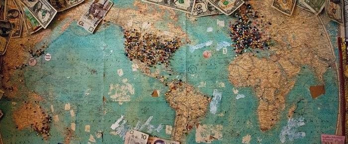 World map with money spread out on it World map with money spread out on it